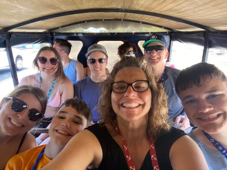 Family boat tour in Minnesota with smiling faces and scenic views.