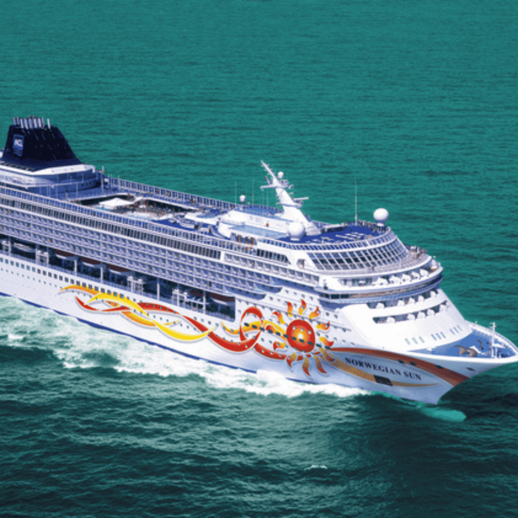 Cruise ship Norwegian Sun sailing in open sea during daytime.