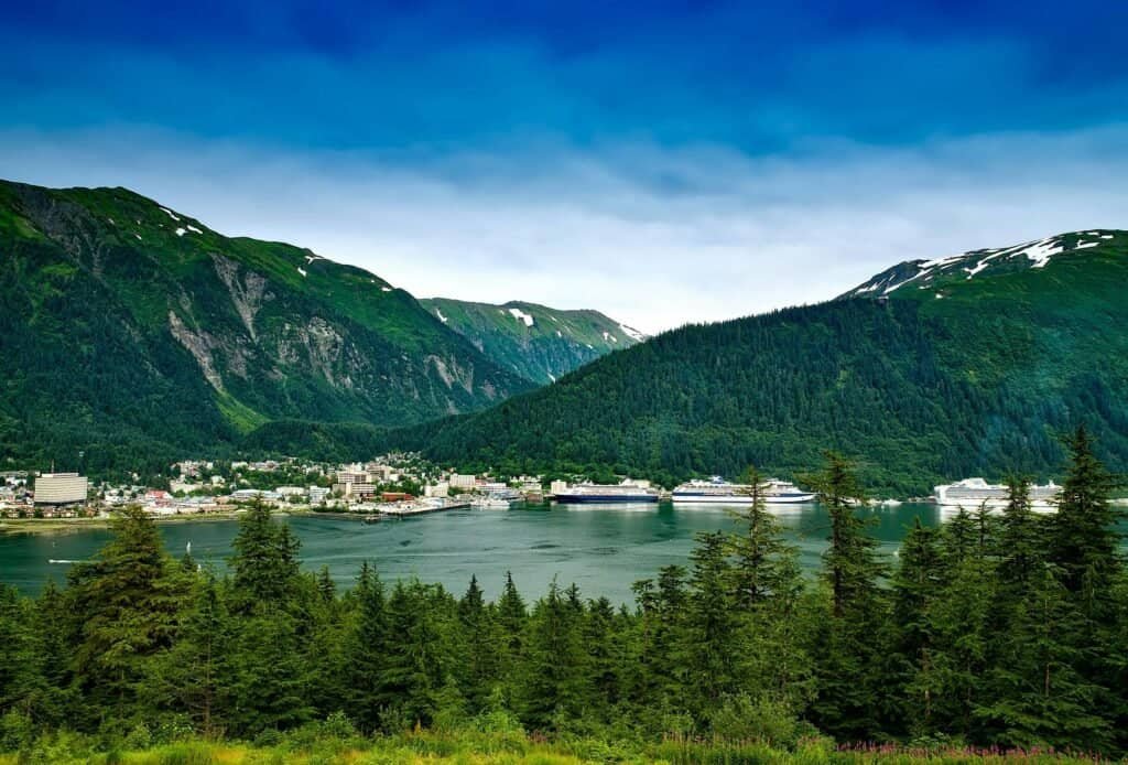 Beautiful Alaskan fjord with mountains and cruise ships.