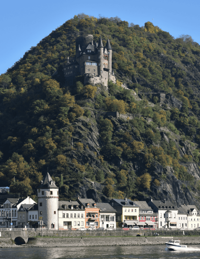 Medieval castle on a hill above a riverside town in Germany.