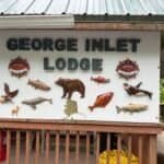 George Inlet Lodge sign with mounted fish and wildlife decorations.